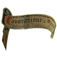 Close up of Empoli Italian glass foil scroll label, reads "Lavorazione a Mano, Fabbricato in Toscana - Italia".